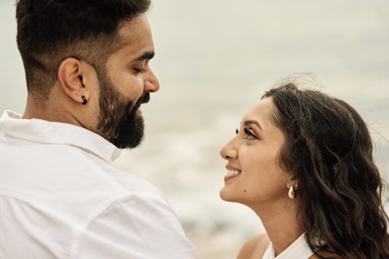 Close-up profile shot of an engaged couple sharing a romantic moment by the Mediterranean sea.