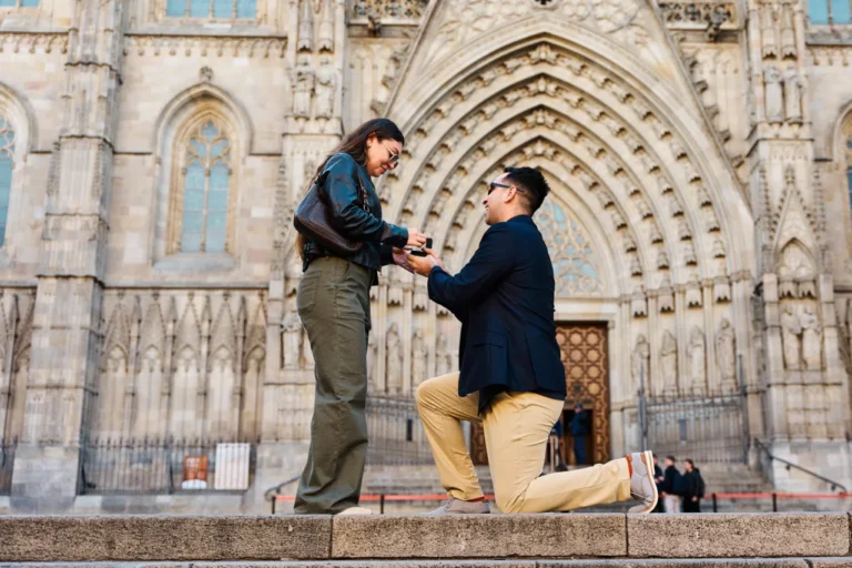Candid engagement moment captured with warm sunlight at Barcelona Cathedral