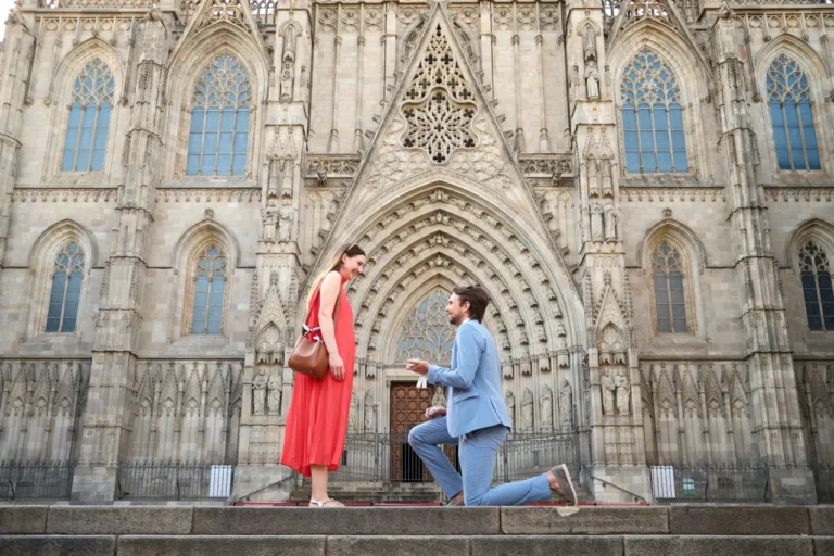 Tender couple proposal framed by the medieval architecture of Barcelona's Old Town.