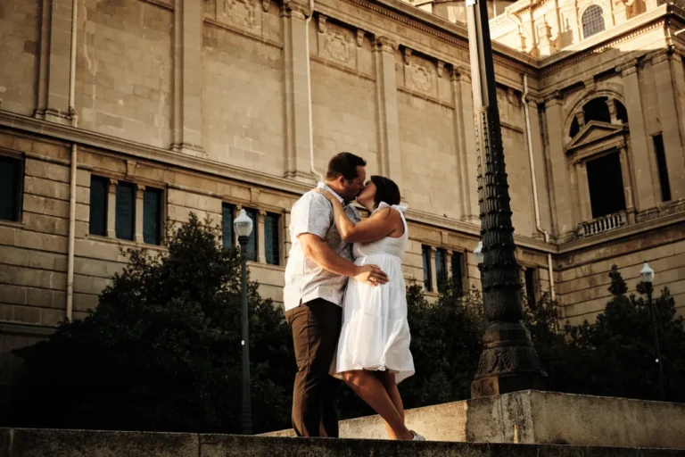 Newly engaged couple walking together on the scenic terrace overlooking Plaça d'Espanya.