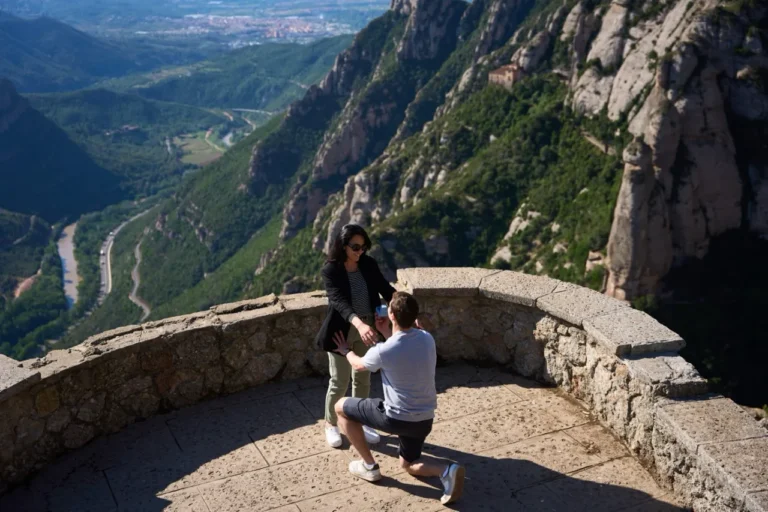 Marriage proposal on one knee at the edge of the Montserrat mountain cliffs with panoramic views.