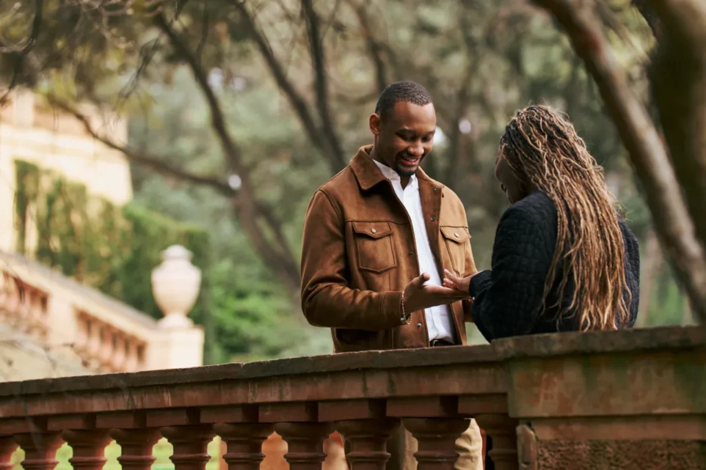 Surprise marriage proposal on a historic stone balcony overlooking the cypress maze of Horta.