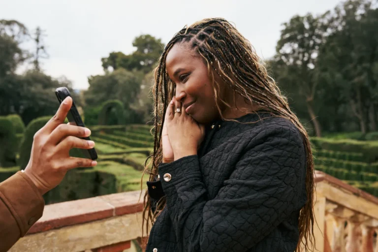 A bride-to-be looks at her engagement ring while taking a selfie in the Horta Labyrinth gardens.