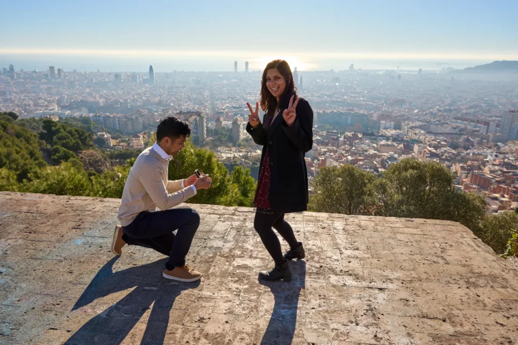 Man kneeling for a surprise proposal during the golden hour at Bunkers del Carmel.