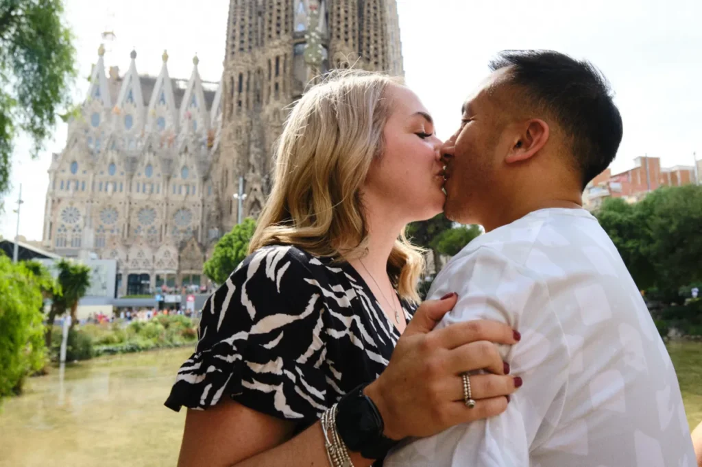 Emotional embrace of a newly engaged couple at the Sagrada Familia viewpoint.