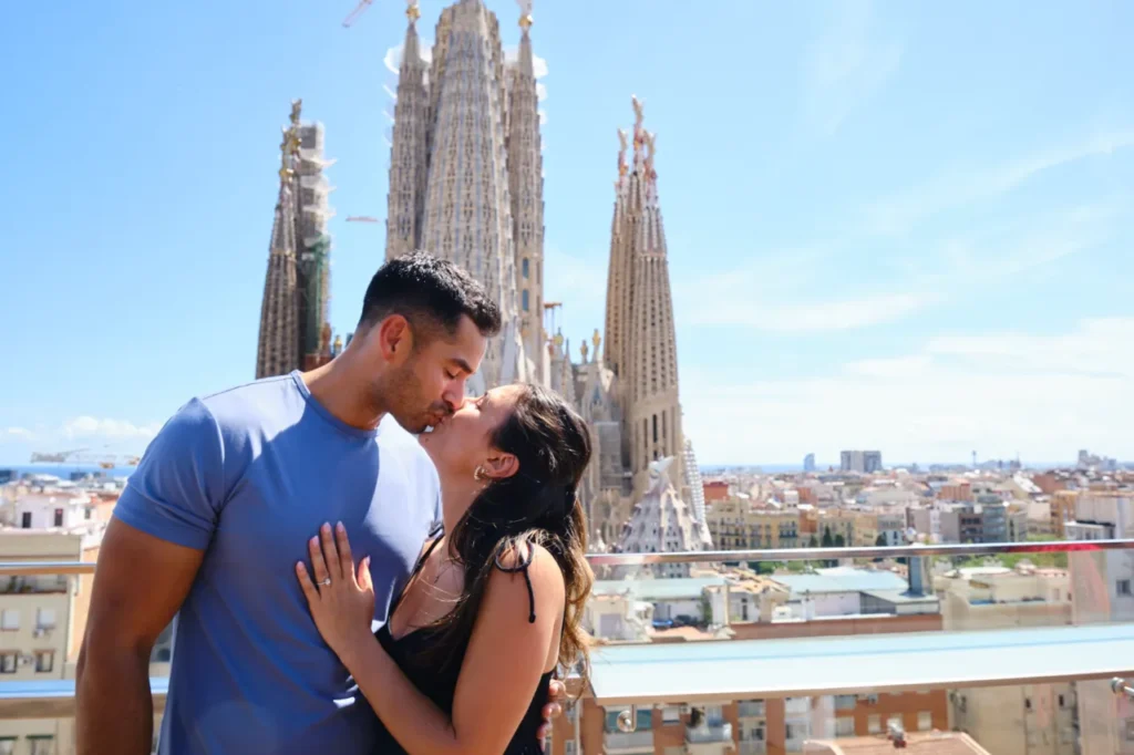 Intimate portrait of a couple in front of the Sagrada Familia's architectural details.