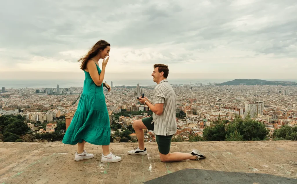 Surprise wedding proposal on one knee with a scenic view of Barcelona city.