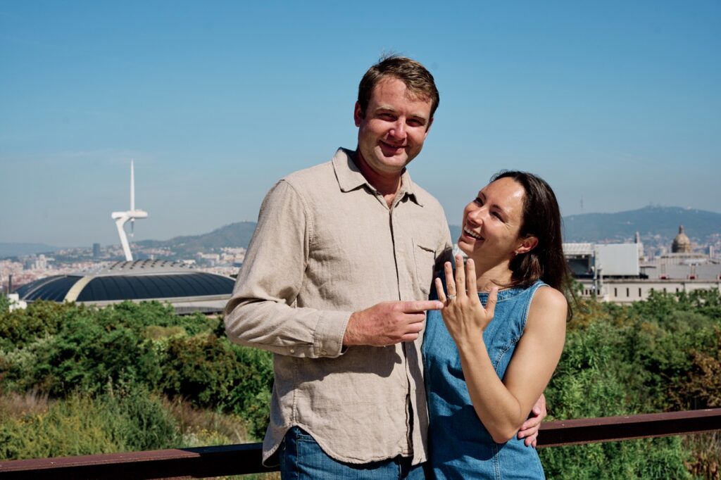 Couple celebrating engagement with ring in barcelona