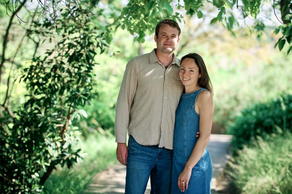 Happy couple celebrating engagement in botanic garden