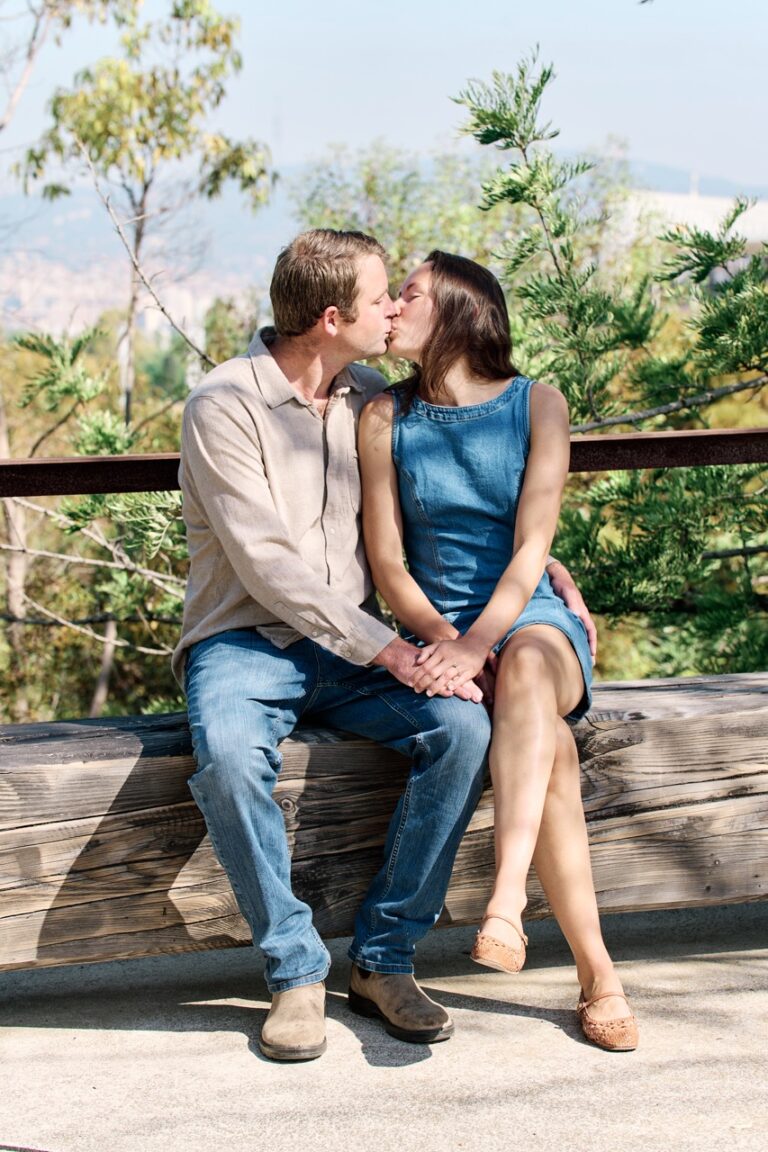 Couple kissing during romantic proposal jardi botanic barcelona montjuic