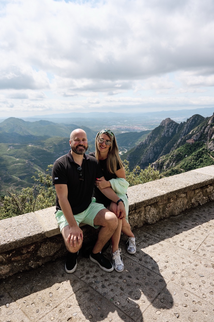 Romantic couple traveling in montserrat mountains proposing marriage
