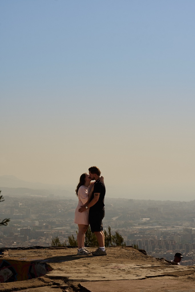 Couple kissing after marriage proposal at bunkers del carmel barcelona photographer