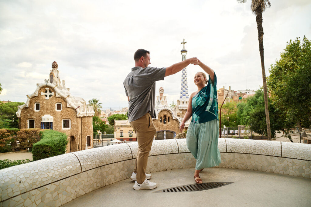 Engagement photos at Park Güell after the proposal, the couple dancing on the terrace