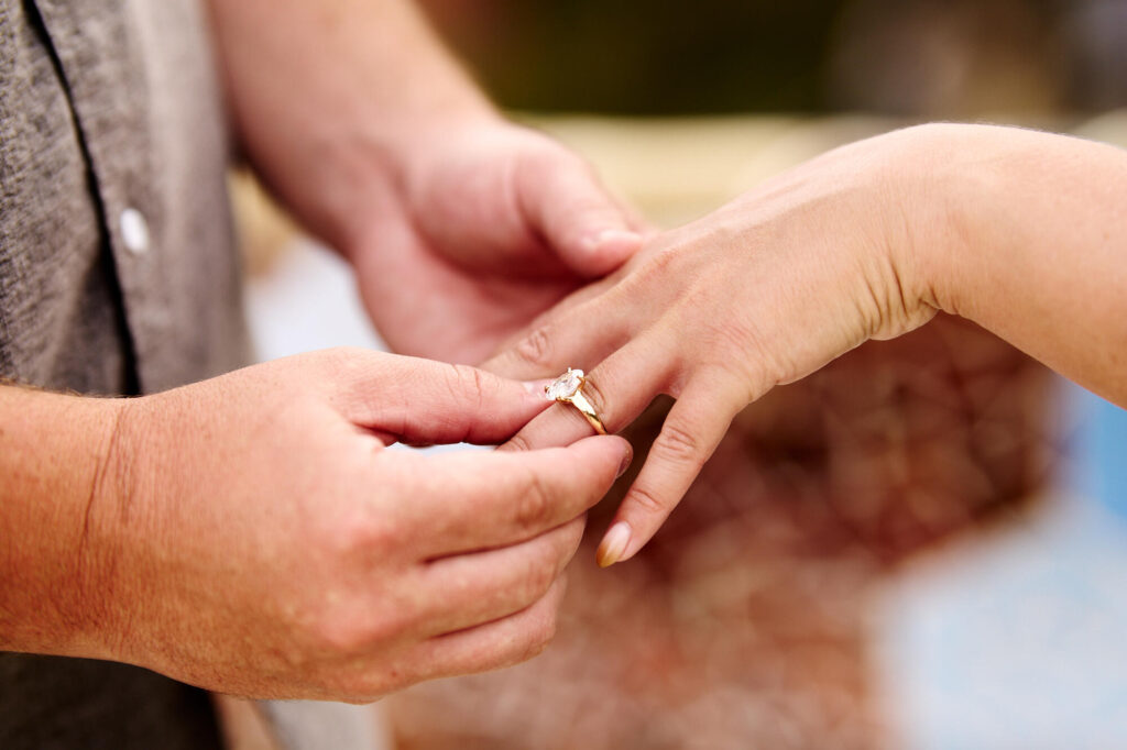 Close-up of the engagement ring being placed on her finger after the proposal in Barcelona