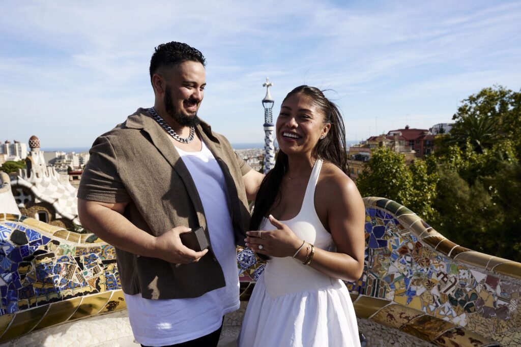 Couple laughing together during their engagement photoshoot at Park Güell after the proposal