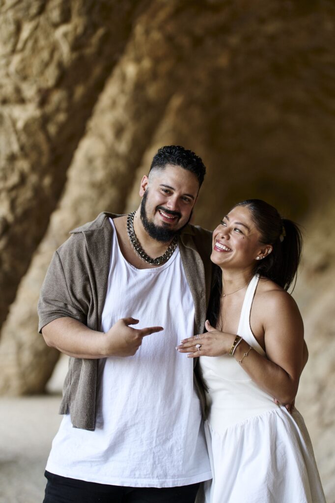 Newly engaged couple laughing in the warm late afternoon light of Park Güell