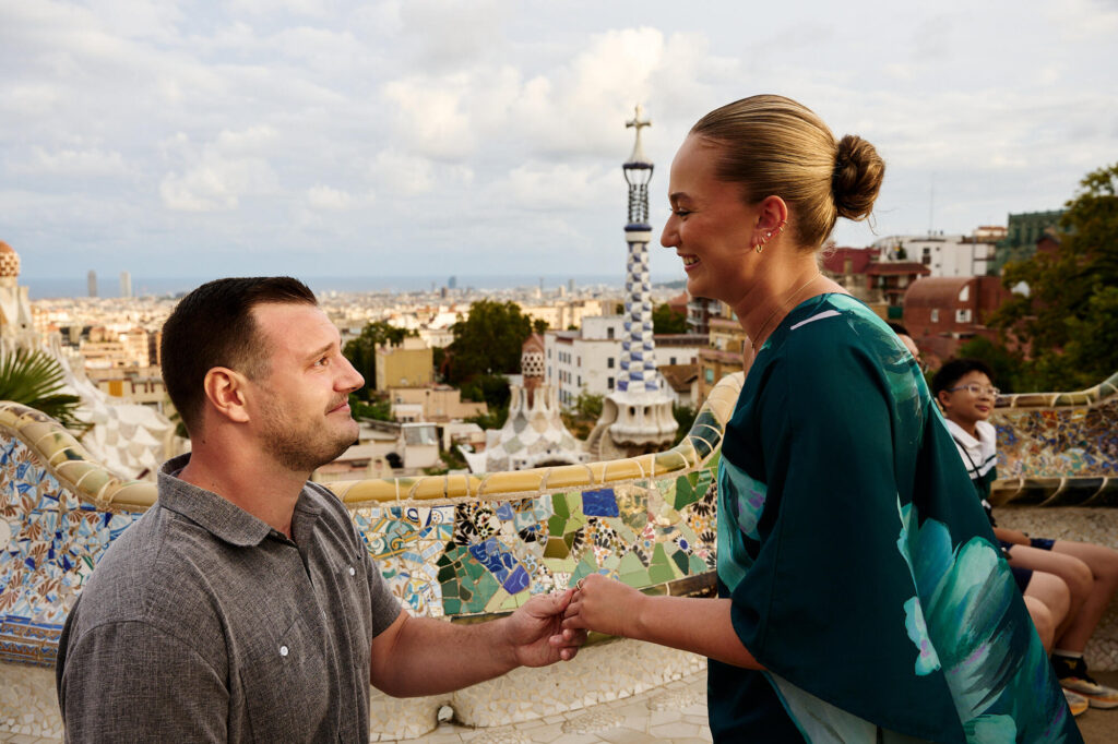 She said yes — woman laughing as her partner proposes at Park Güell, Barcelona